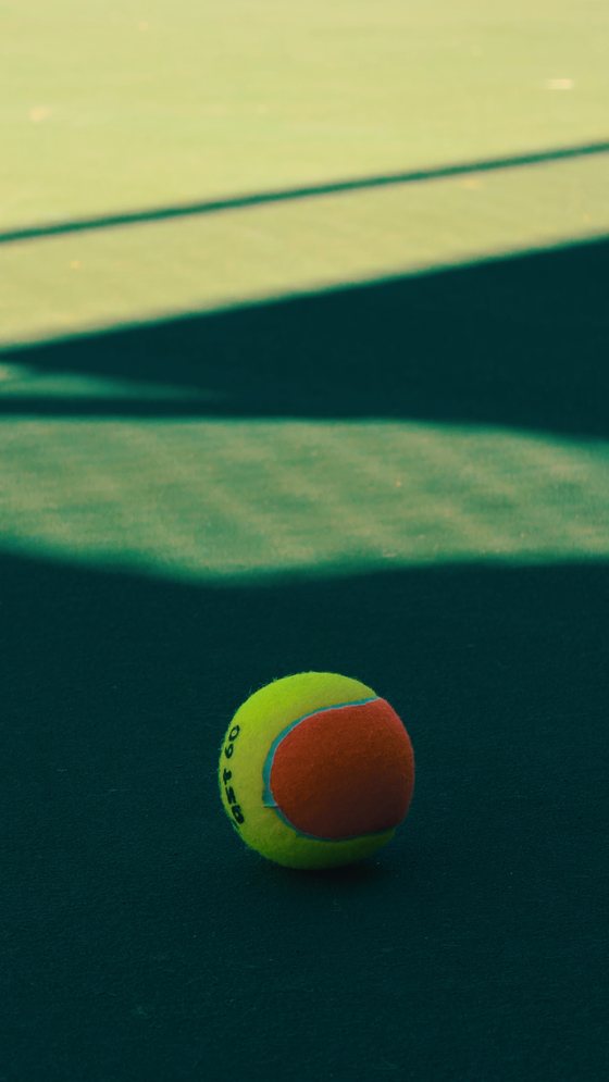 The delivered file — a tall 9:16 photograph of a tennis ball on a court with the look already applied